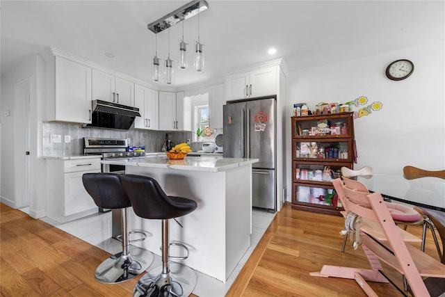 628 151st St, Whitestone, NY 11357 - kitchen featuring stainless steel appliances, under cabinet range hood, white cabinetry, light countertops, and recessed lighting