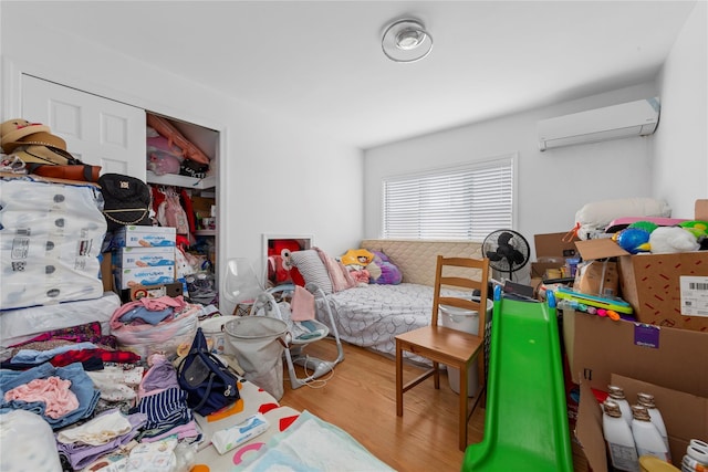 628 151st St, Whitestone, NY 11357 - bedroom featuring an AC wall unit, wood finished floors, and a closet