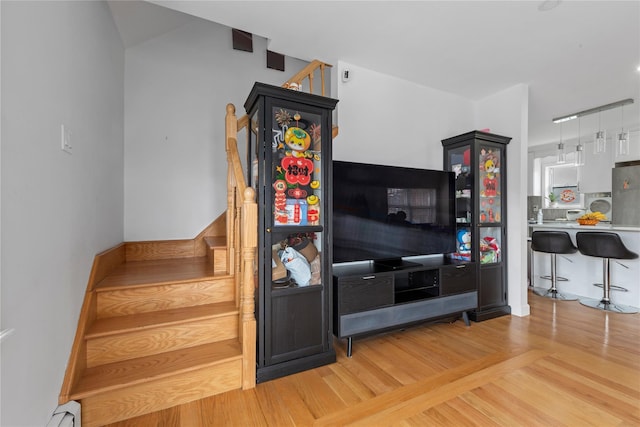 628 151st St, Whitestone, NY 11357 - living area featuring stairs, baseboard heating, and wood finished floors