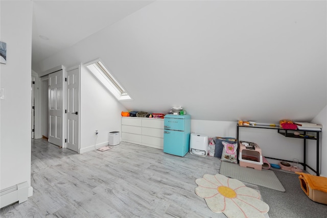 628 151st St, Whitestone, NY 11357 - bonus room featuring a skylight, a baseboard heating unit, wood finished floors, and lofted ceiling