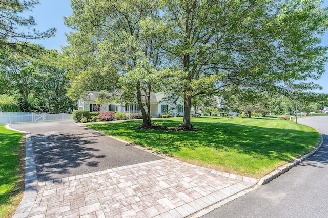 67 Fairway Dr, Wading River, NY 11792 - obstructed view of property featuring decorative driveway and a gate