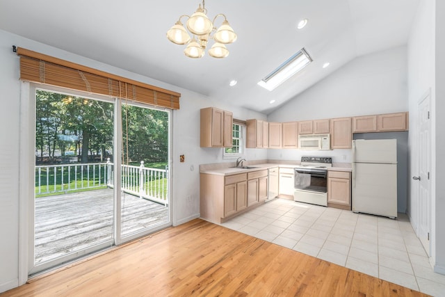 67 Fairway Dr, Wading River, NY 11792 - kitchen with white appliances, light countertops, light wood-style floors, a chandelier, and a sink