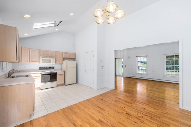 67 Fairway Dr, Wading River, NY 11792 - kitchen featuring white appliances, high vaulted ceiling, light wood finished floors, a skylight, and a sink