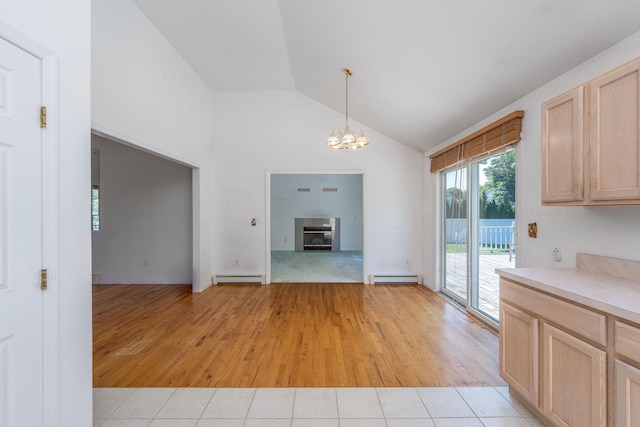67 Fairway Dr, Wading River, NY 11792 - kitchen with a baseboard radiator, baseboard heating, light wood-style floors, light brown cabinets, and a chandelier