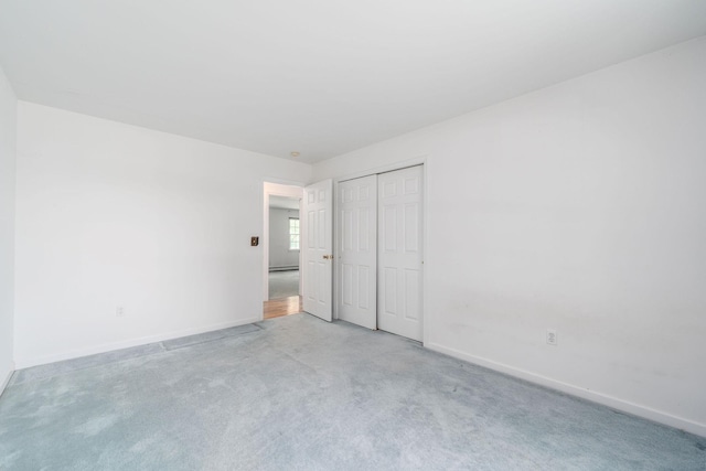 67 Fairway Dr, Wading River, NY 11792 - unfurnished bedroom featuring light carpet, baseboards, and a closet