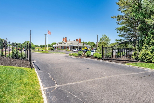 67 Fairway Dr, Wading River, NY 11792 - view of asphalt street with curbs and a gate