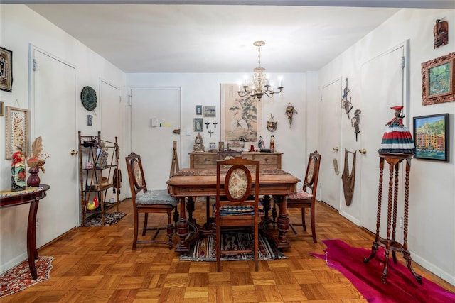490 Atlantic Ave Unit 103, East Rockaway, NY 11518 - dining space featuring a chandelier and baseboards