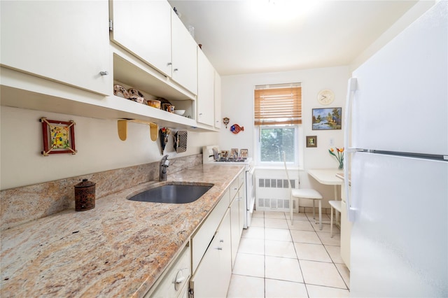 490 Atlantic Ave Unit 103, East Rockaway, NY 11518 - kitchen with white appliances, radiator, a sink, open shelves, and white cabinetry
