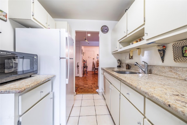 490 Atlantic Ave Unit 103, East Rockaway, NY 11518 - kitchen featuring a sink, black microwave, white cabinets, freestanding refrigerator, and open shelves