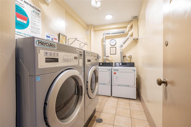 490 Atlantic Ave Unit 103, East Rockaway, NY 11518 - shared laundry featuring washing machine and dryer, light tile patterned floors, and baseboards