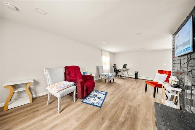 109 Silverleaf Ln, Islandia, NY 11749 - sitting room featuring wood finished floors, a fireplace, baseboards, and a baseboard radiator