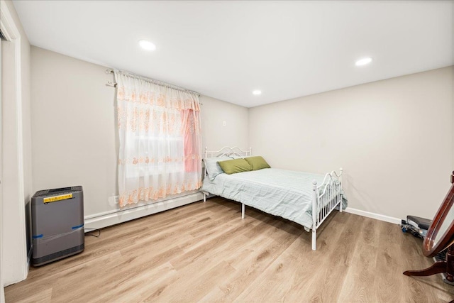 109 Silverleaf Ln, Islandia, NY 11749 - bedroom featuring a baseboard heating unit, wood finished floors, recessed lighting, and baseboards