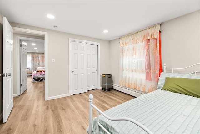 109 Silverleaf Ln, Islandia, NY 11749 - bedroom featuring a baseboard heating unit, light wood-style floors, recessed lighting, baseboards, and a closet