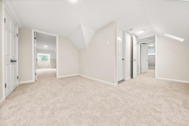 109 Silverleaf Ln, Islandia, NY 11749 - additional living space with vaulted ceiling, carpet floors, and baseboards