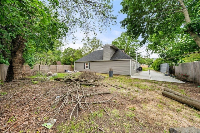 109 Silverleaf Ln, Islandia, NY 11749 - rear view of property featuring a patio area, a fenced backyard, and a shingled roof