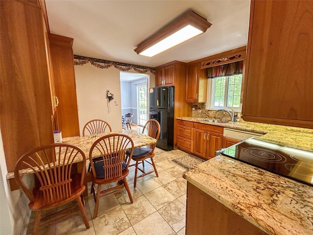 3 Johnston Rd, Livingston Manor, NY 12758 - kitchen featuring freestanding refrigerator, backsplash, brown cabinets, and light stone counters