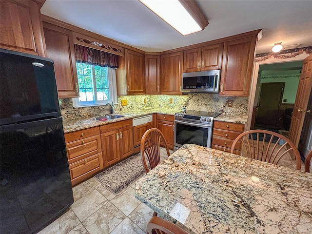 3 Johnston Rd, Livingston Manor, NY 12758 - kitchen with appliances with stainless steel finishes, tasteful backsplash, and brown cabinetry