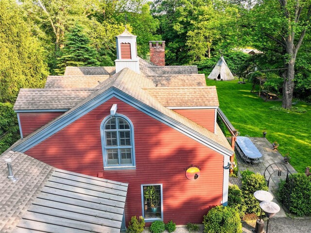 501 Guard Hill Rd, Bedford, NY 10506 - view of home's exterior with a yard, a shingled roof, a patio area, and a chimney