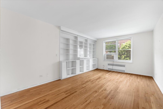 112-20 72nd Dr Unit A33, Forest Hills, NY 11375 - unfurnished room featuring radiator, wood finished floors, and cooling unit