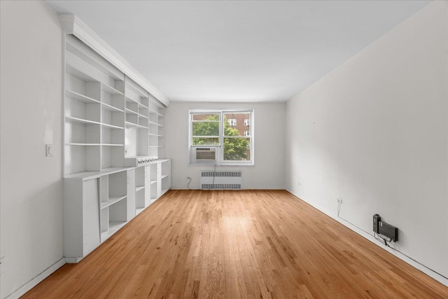 112-20 72nd Dr Unit A33, Forest Hills, NY 11375 - unfurnished living room with radiator heating unit, light wood finished floors, and cooling unit