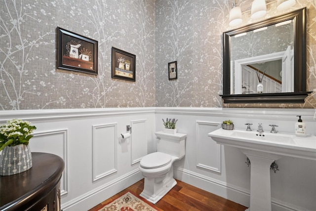 383 Illington Rd, Ossining, NY 10562 - bathroom with wallpapered walls, wainscoting, wood finished floors, and a decorative wall