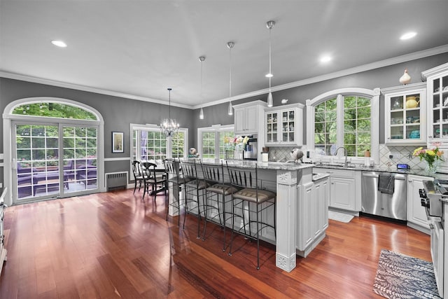 383 Illington Rd, Ossining, NY 10562 - kitchen featuring appliances with stainless steel finishes, radiator heating unit, a center island, dark wood-style floors, and recessed lighting
