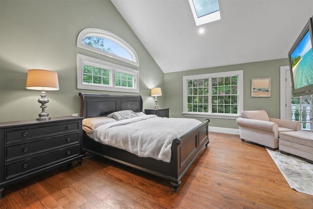 383 Illington Rd, Ossining, NY 10562 - bedroom with high vaulted ceiling, a skylight, and dark wood-style flooring