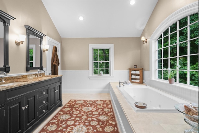 383 Illington Rd, Ossining, NY 10562 - bathroom featuring wainscoting, double vanity, a whirlpool tub, tile patterned flooring, and lofted ceiling