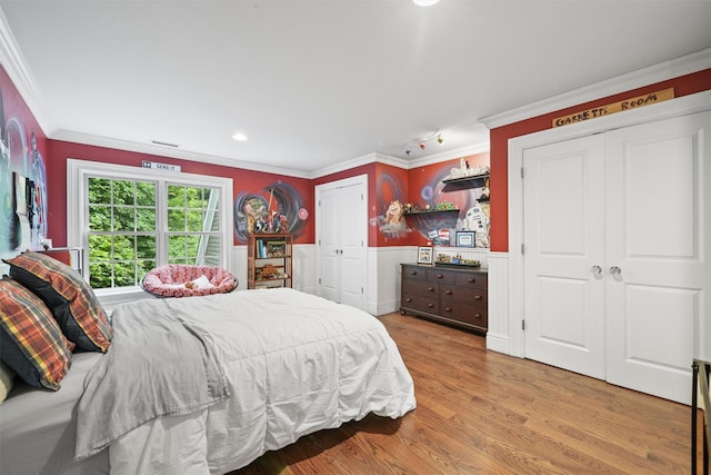383 Illington Rd, Ossining, NY 10562 - bedroom featuring two closets, ornamental molding, wood finished floors, wainscoting, and recessed lighting