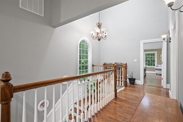 383 Illington Rd, Ossining, NY 10562 - hall featuring a chandelier, wood finished floors, an upstairs landing, and a towering ceiling