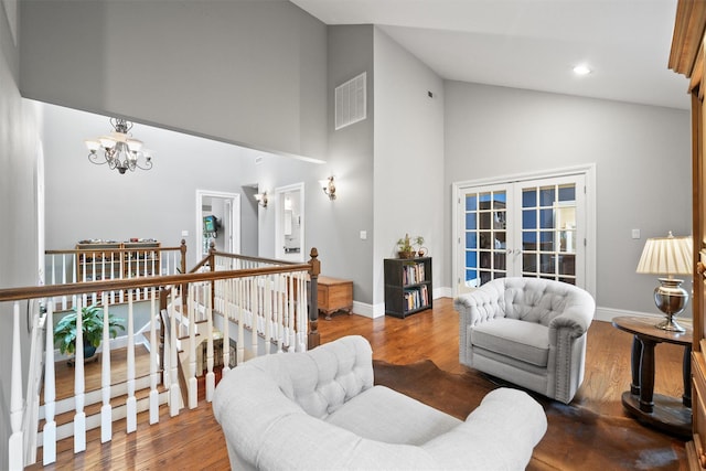383 Illington Rd, Ossining, NY 10562 - living area with high vaulted ceiling, a chandelier, french doors, wood finished floors, and recessed lighting