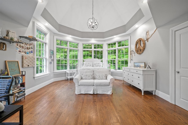 383 Illington Rd, Ossining, NY 10562 - living area with a chandelier, plenty of natural light, wood finished floors, and vaulted ceiling