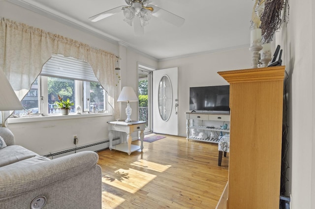 1125 Reilly St, Bay Shore, NY 11706 - living area with crown molding, a ceiling fan, wood finished floors, and a baseboard heating unit