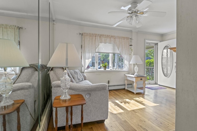 1125 Reilly St, Bay Shore, NY 11706 - living area featuring crown molding, a baseboard heating unit, a ceiling fan, and wood finished floors