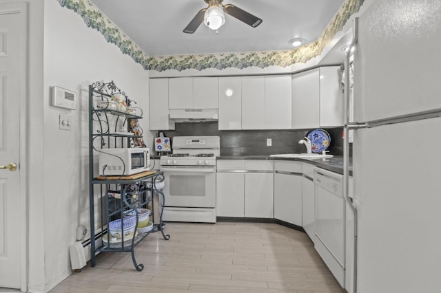 1125 Reilly St, Bay Shore, NY 11706 - kitchen featuring white appliances, under cabinet range hood, white cabinets, decorative backsplash, and a ceiling fan