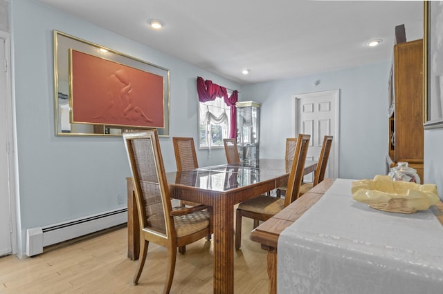1125 Reilly St, Bay Shore, NY 11706 - dining room featuring a baseboard radiator, light wood-style flooring, and recessed lighting