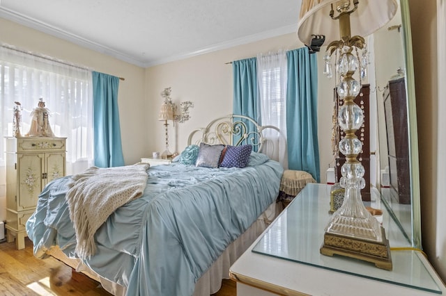 1125 Reilly St, Bay Shore, NY 11706 - bedroom with wood finished floors and ornamental molding