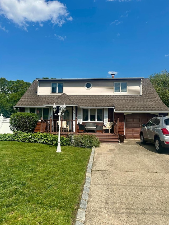 1125 Reilly St, Bay Shore, NY 11706 - view of front of house featuring a porch, concrete driveway, a front yard, a garage, and a shingled roof