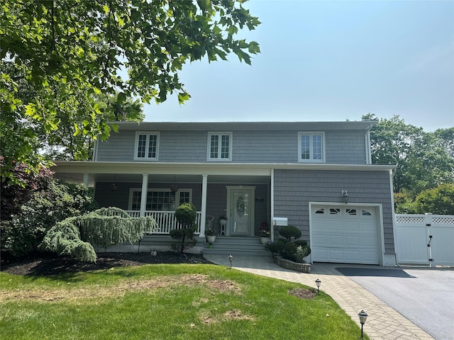 43 Clafford Ln, Melville, NY 11747 - view of front of house featuring a garage, covered porch, driveway, and a gate