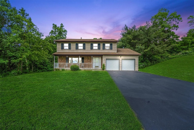 14 Cheesecote Ct, Stony Point, NY 10980 - traditional-style home with a porch, asphalt driveway, a front yard, a garage, and brick siding