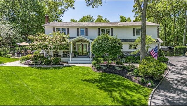 10 Woods Edge Ct, Hauppauge, NY 11788 - view of front facade with a front yard and a chimney
