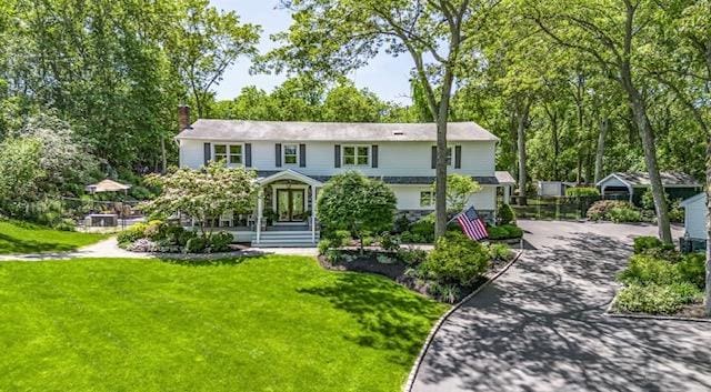 10 Woods Edge Ct, Hauppauge, NY 11788 - view of front of property with driveway, a front yard, and a chimney