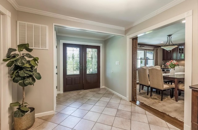 10 Woods Edge Ct, Hauppauge, NY 11788 - foyer entrance featuring french doors, baseboards, ornamental molding, and light tile patterned floors