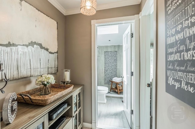 10 Woods Edge Ct, Hauppauge, NY 11788 - hall with crown molding, a chandelier, and baseboards