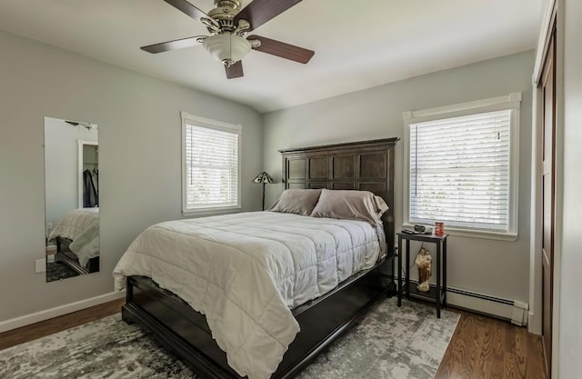 10 Woods Edge Ct, Hauppauge, NY 11788 - bedroom featuring wood finished floors, baseboards, baseboard heating, a ceiling fan, and a closet