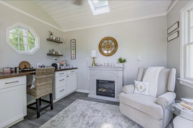 10 Woods Edge Ct, Hauppauge, NY 11788 - home office featuring dark wood-style flooring, vaulted ceiling, a skylight, a glass covered fireplace, and ornamental molding