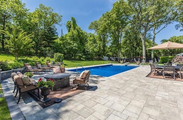 10 Woods Edge Ct, Hauppauge, NY 11788 - outdoor pool with a patio and view of scattered trees