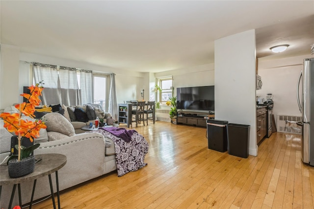12399 Flatlands Ave Unit 7C, Brooklyn, NY 11207 - living room featuring light wood finished floors and radiator heating unit