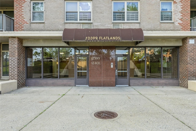 12399 Flatlands Ave Unit 7C, Brooklyn, NY 11207 - view of exterior entry with brick siding