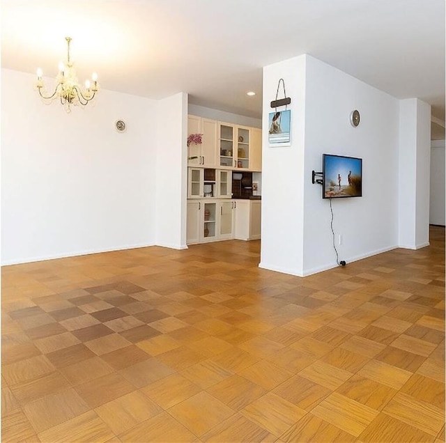 40 Brighton 1st Rd Unit 12H, Brooklyn, NY 11235 - unfurnished living room with a chandelier, baseboards, and recessed lighting
